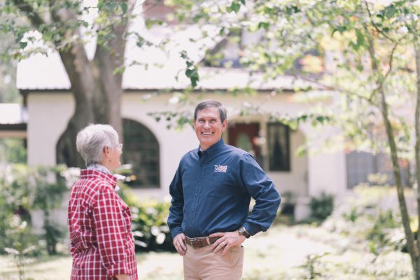 Dale Tadlock, President of Tadlock Roofing, poses with a homeowner