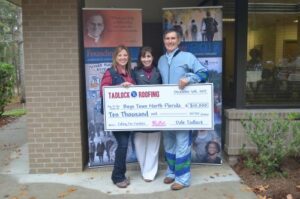Dale and Pamela Tadlock Present Boys Town North Florida Development Director Dena Strickland with $10,000 check.