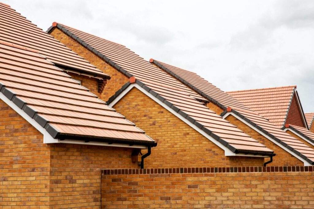 exterior view of yellow brick row house with yellow roof tiles