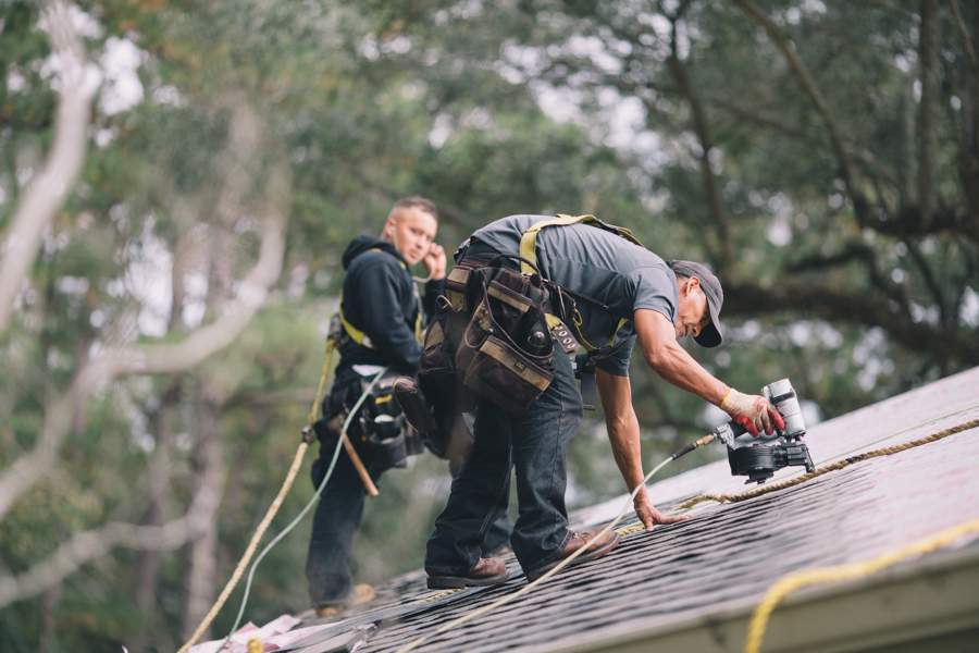 Tadlock workers: Candid photo of them working on the roofing.